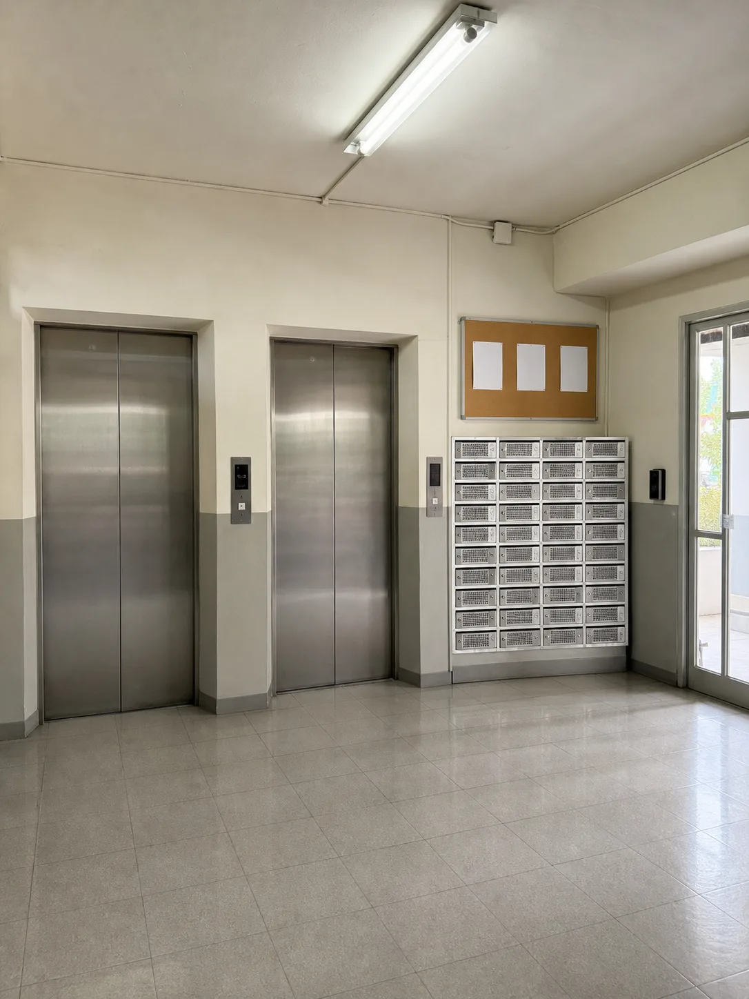 The ground-floor lift lobby with mailboxes and the keycard reader