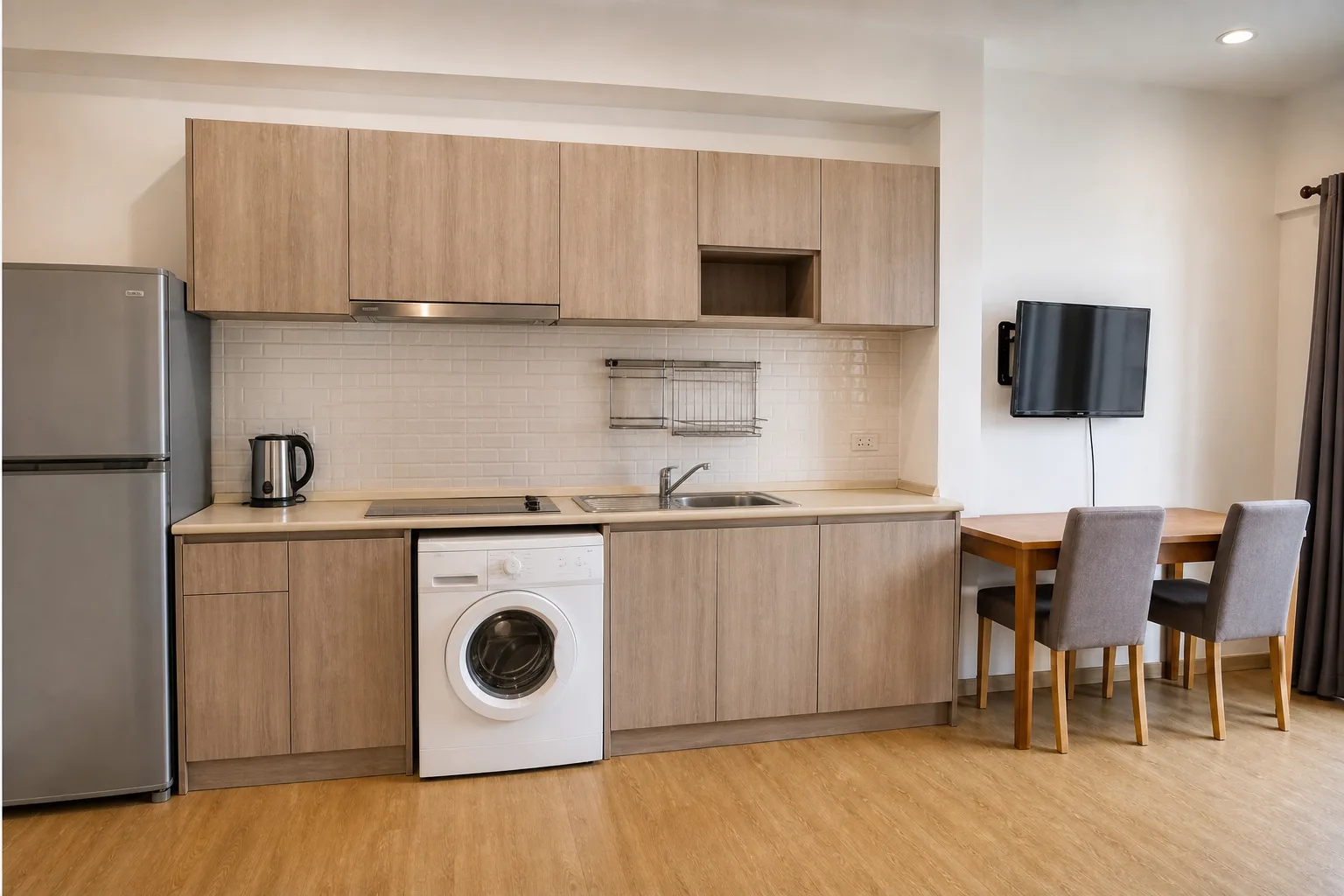 The kitchenette in the one bedroom, with sink, induction hob and counter storage