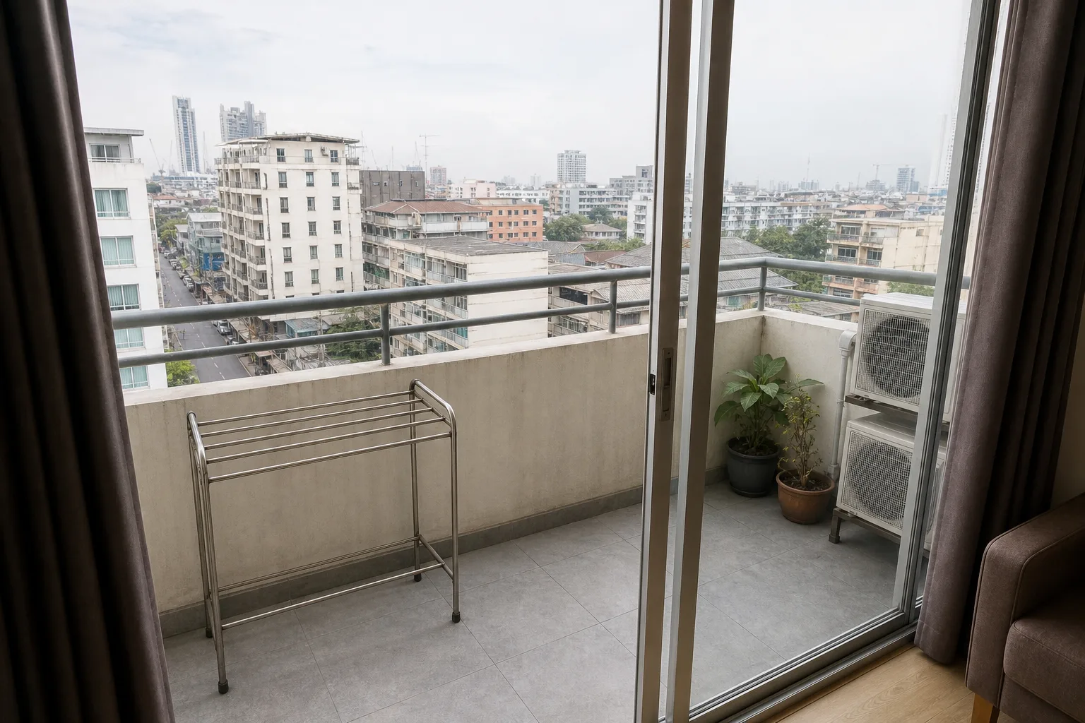 The balcony of the two bedrooms, with a drying rail and a view over the soi